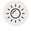 Ein schwarzer Sonnen-Icon mit einem Kreis in der Mitte, umgeben von kurzen Strahlen, auf hellgrauem Hintergrund.